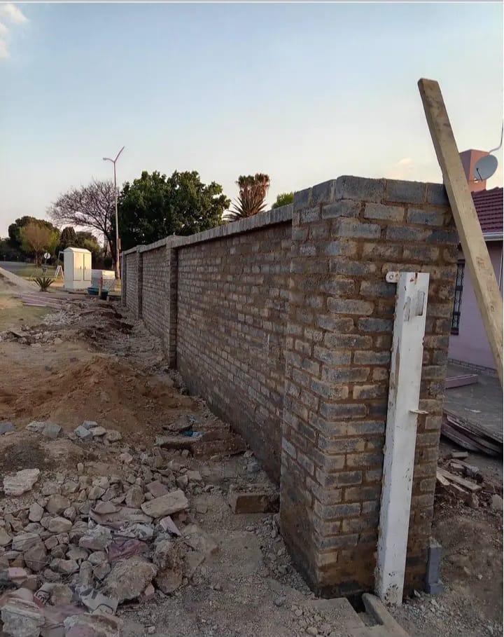 Long newly built brick boundary wall