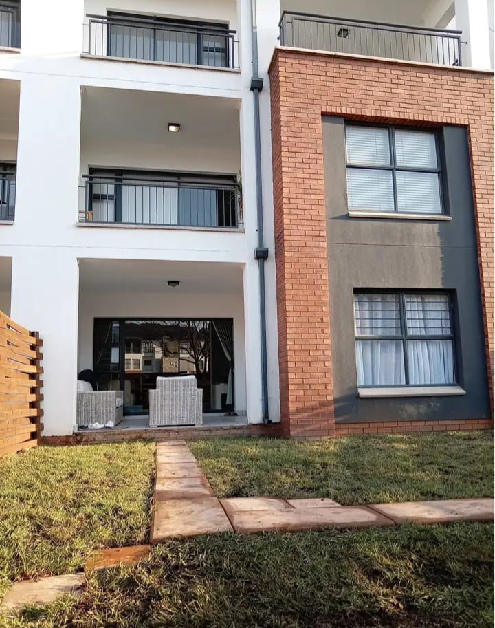 Landscaped residential courtyard in front of a brick building