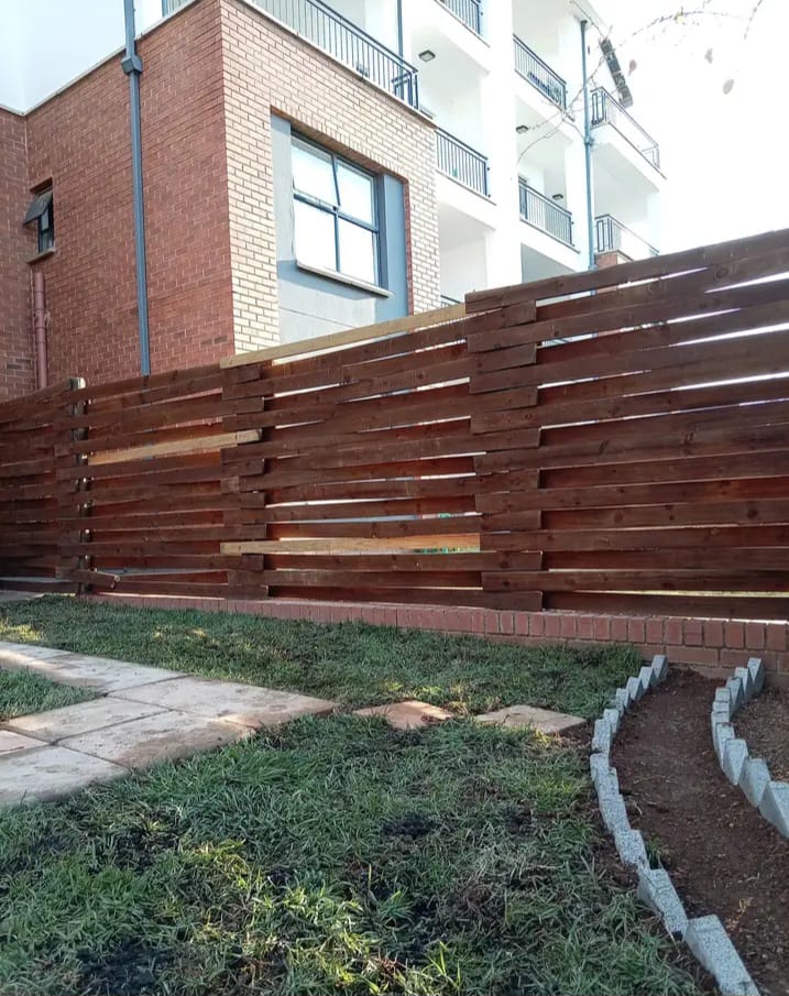 Landscaped courtyard with timber boundary fence and planting bed