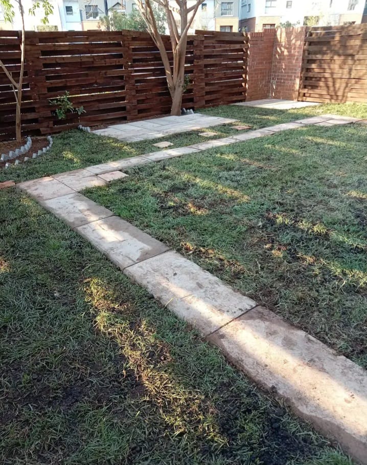 Completed landscaped garden with paved walkways and lawn